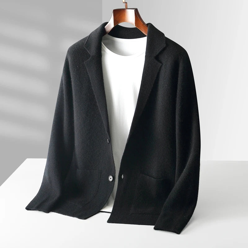 A black business casual cardigan with two front pockets is displayed on a hanger over a plain white t-shirt, set against a minimal, light gray background—perfect as an autumn winter knit cardigan for effortless style.