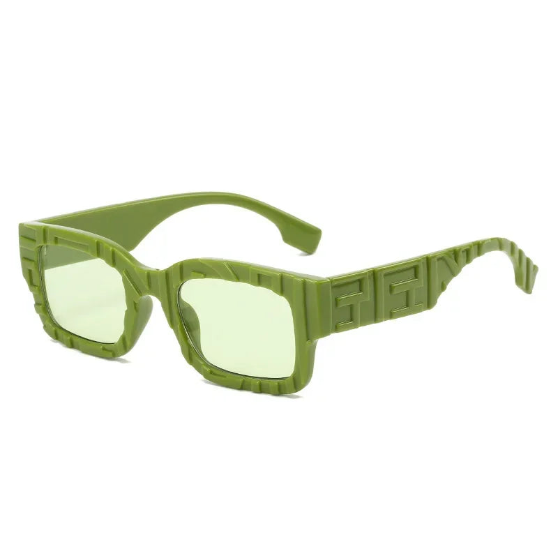 Green rectangular vintage sunglasses with geometric patterns on the frames and temples. The lightly tinted green lenses offer UV400 protection, while bold, chunky lines create a modern, stylish look.