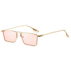 Avalon Sunglasses feature gold frames and rectangular lenses with a modern, minimalist design. The thin arms and pink-tinted lenses add a stylish touch, shown angled slightly to the right on a white background.