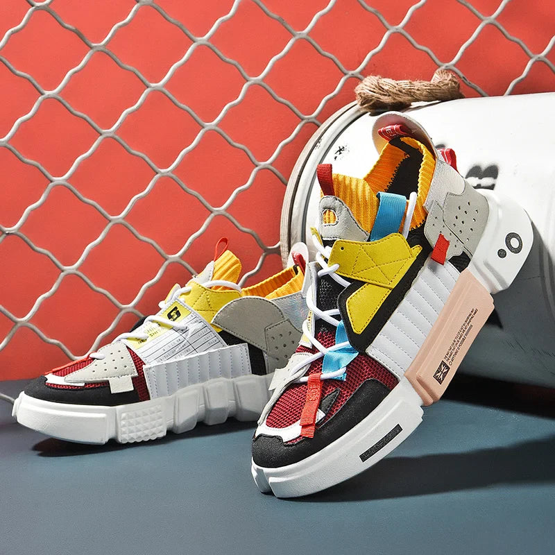 A pair of chunky, multi-colored Extreme VS7 Sneakers with bold patterns and geometric shapes are displayed against a red, lattice-patterned background, with one shoe propped up and the other lying flat—perfect for streetwear sneaker fans.