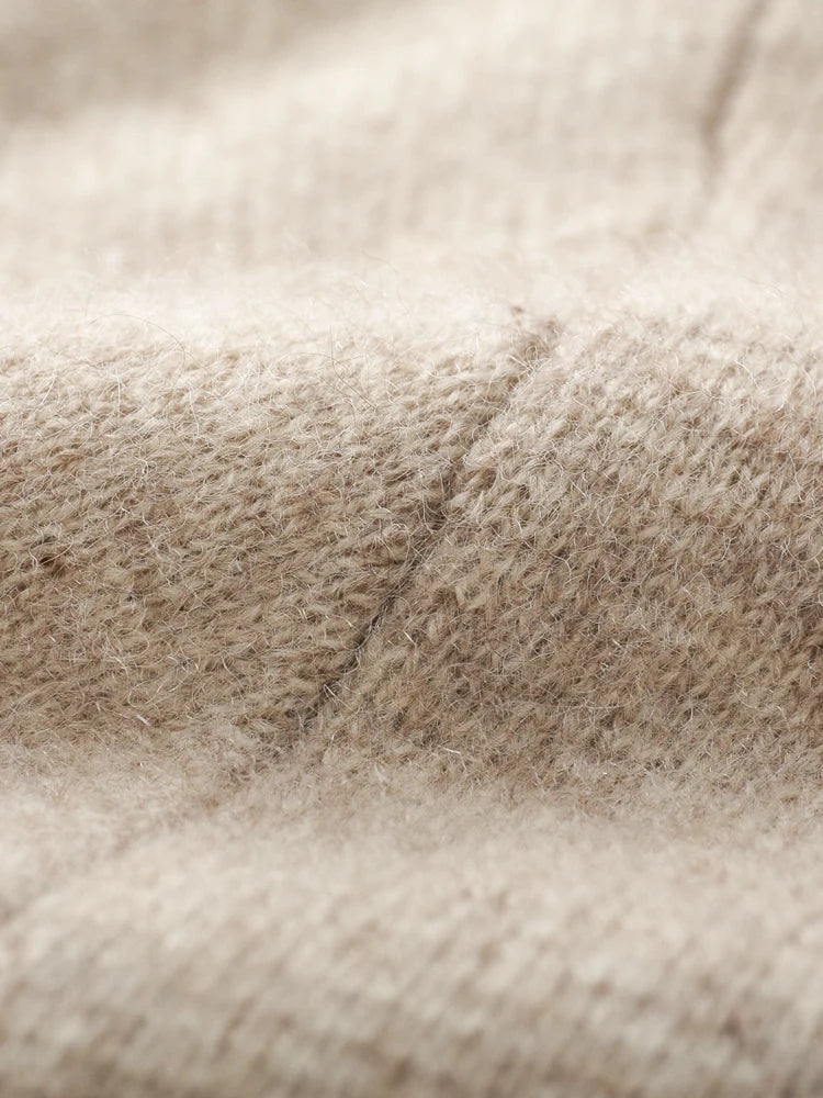 Close-up of a beige knit cardigan, highlighting its soft, fuzzy texture and detailed stitching—perfect for an autumn winter cardigan.