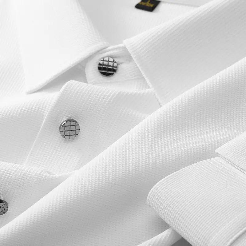 Close-up of a wrinkle-resistant shirt with textured fabric, silver grid-patterned buttons, and a neatly folded collar.