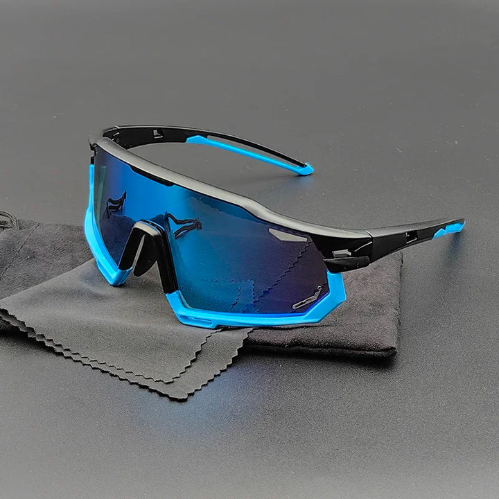 Blue and black Olympus Sunglasses with reflective, polarized lenses offer UV protection as they rest on a gray cleaning cloth and black pouch, set against a plain dark background.