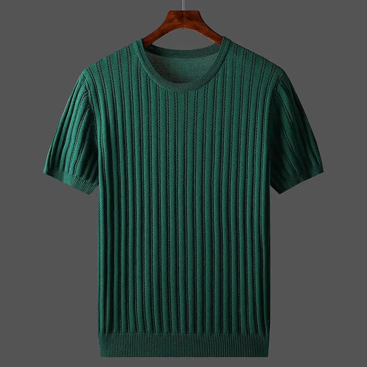 A green, short-sleeved, ribbed knit cashmere-cotton tee with a classic fit hangs on a wooden hanger against a plain gray background.