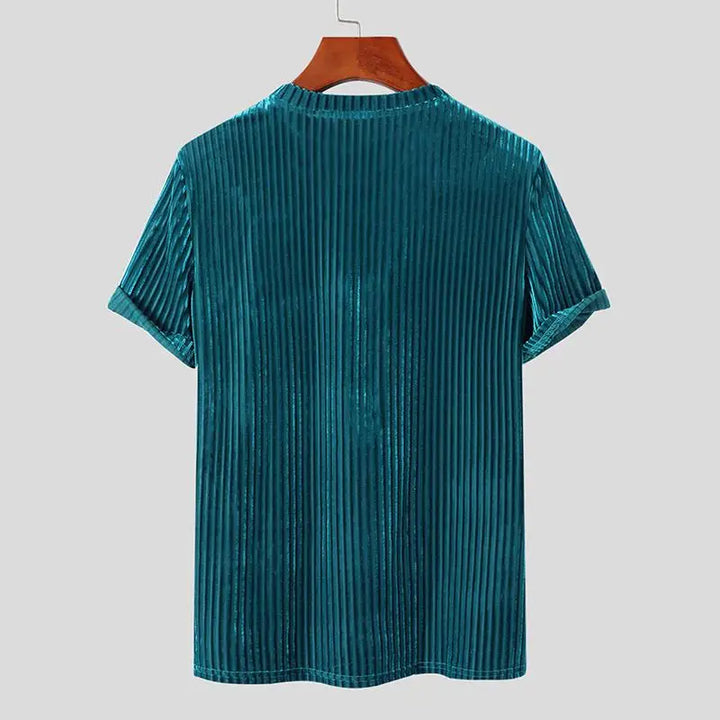 A teal short-sleeved stripe corduroy tee with vertical ridges and a classic fit, displayed on a wooden hanger against a plain light gray background.