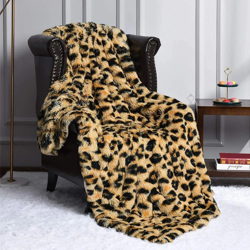 A plush throw in leopard print drapes over a dark armchair in a stylish room with white paneled walls, a side table with books and decor, and a fluffy white rug on the floor.