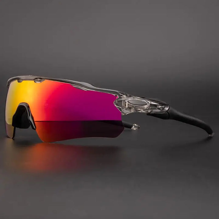 A pair of Polarized Cycling Sunglasses with a semi-rimless clear frame, black arms, and large, mirrored lenses that blend from yellow to pink, offering UV Protection against a dark gray background.