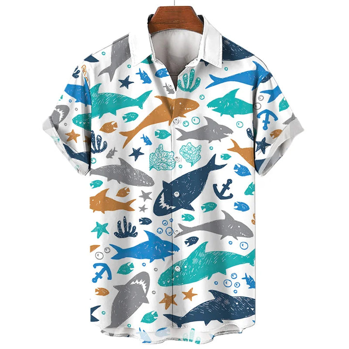 Short-sleeve, button-up shirt with a white background featuring a summer-ready, ocean-inspired pattern of sharks, anchors, seaweed, bubbles, fish, starfish, and crowns in blue, teal, orange, and gray.