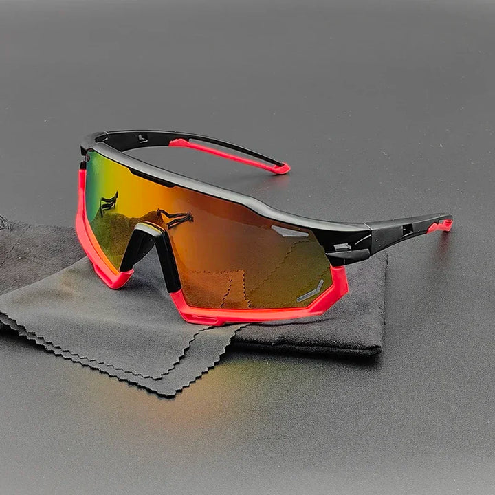 Olympus Sunglasses with a black and red frame and reflective, multicolored polarized lenses rest on a black cleaning cloth against a dark background, offering both style and UV protection.