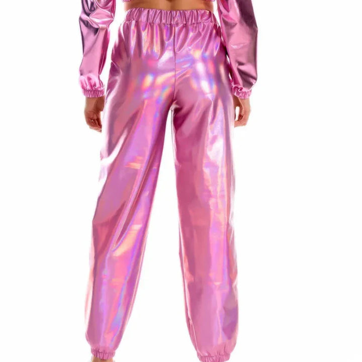 A person wearing shiny, metallic pink pants with an elastic high waist and a matching long-sleeve top, shown from the back against a white background. The loose fit fabric has an iridescent, holographic sheen.