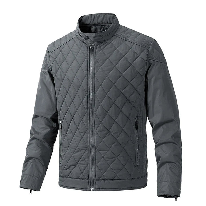 Gray quilted slim-fit jacket with a front zipper, stand-up collar, and two zippered side pockets. The diamond-patterned stitch design on the torso and upper sleeves pairs with wind-resistant fabric for extra comfort.