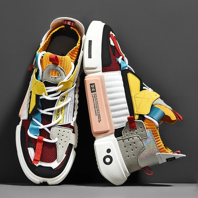 A pair of colorful, futuristic Extreme VS7 Sneakers with chunky soles, featuring red, yellow, blue, gray, black, and white elements. These lightweight breathable sneakers have mesh and leather panels, unique laces, and bold streetwear details.