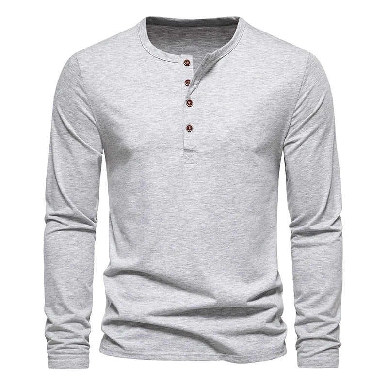 A light gray long-sleeve Henley shirt with a round neckline and four brown buttons on the placket, crafted from breathable cotton for comfort, displayed on a plain white background.