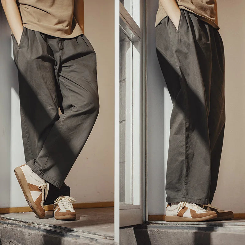 Two side-by-side photos show a person wearing loose-fitting dark gray pants, a beige shirt, and lightweight breathable sneakers with EVA midsole cushioning. The beige sneakers with white soles add comfort as they stand indoors by the window, hands in pockets.