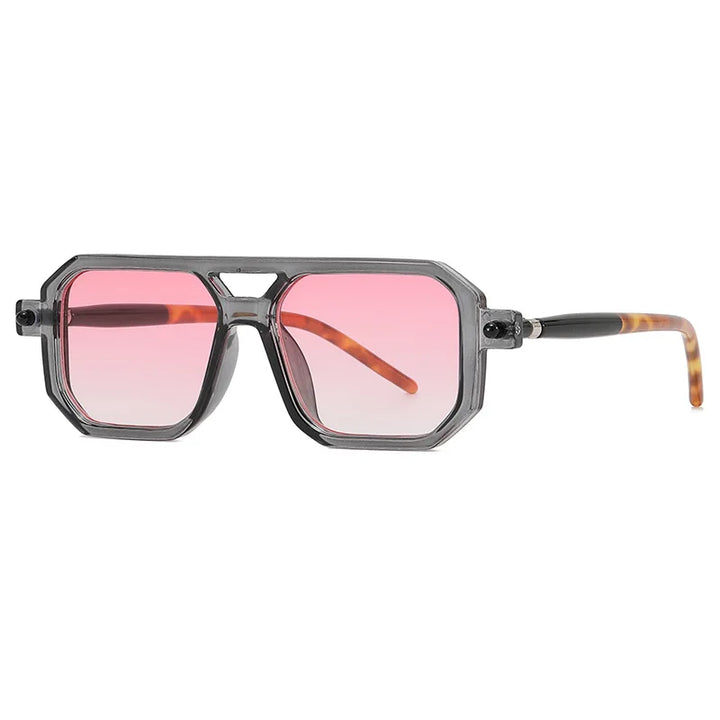 Geometric sunglasses with a translucent gray frame, pink-tinted lenses, and brown tortoiseshell-patterned arms feature a striking geometric silhouette and offer UV protection, shown on a white background.