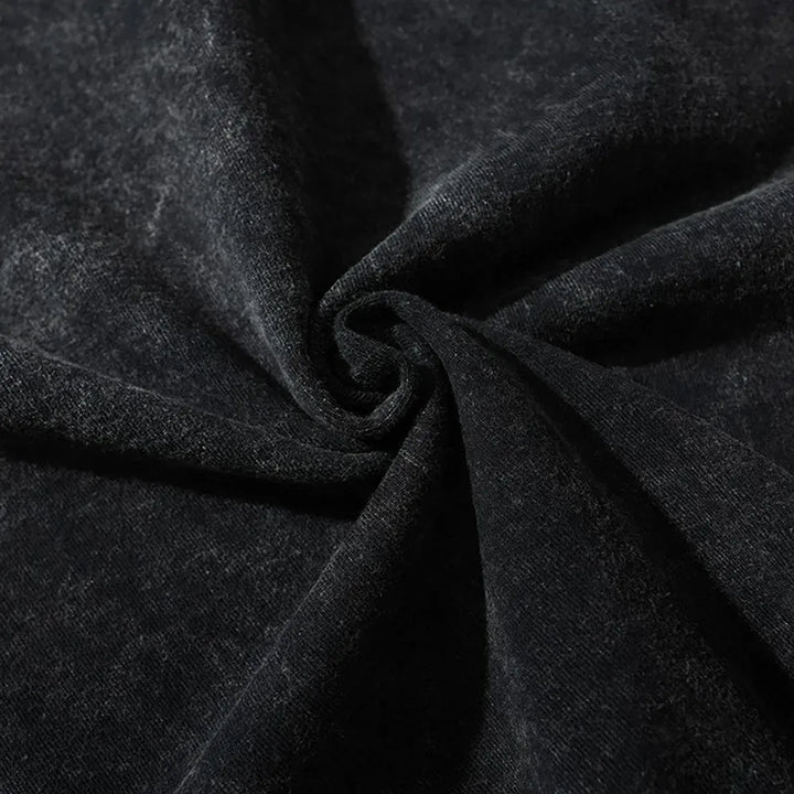 Close-up of black velvet fabric with a soft, slightly shiny texture, gathered and twisted in the center to create gentle folds and a spiral pattern—perfect inspiration for graphic design projects.