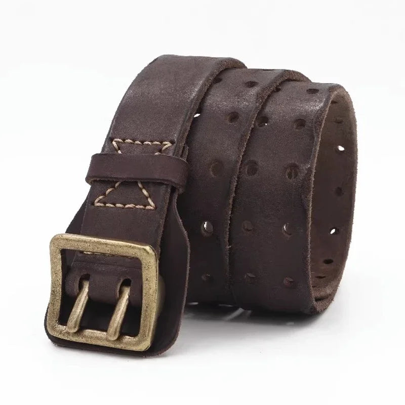 A rolled-up dark brown cowhide belt with a brass buckle and multiple holes along its length, displayed on a white background for a rugged aesthetic.
