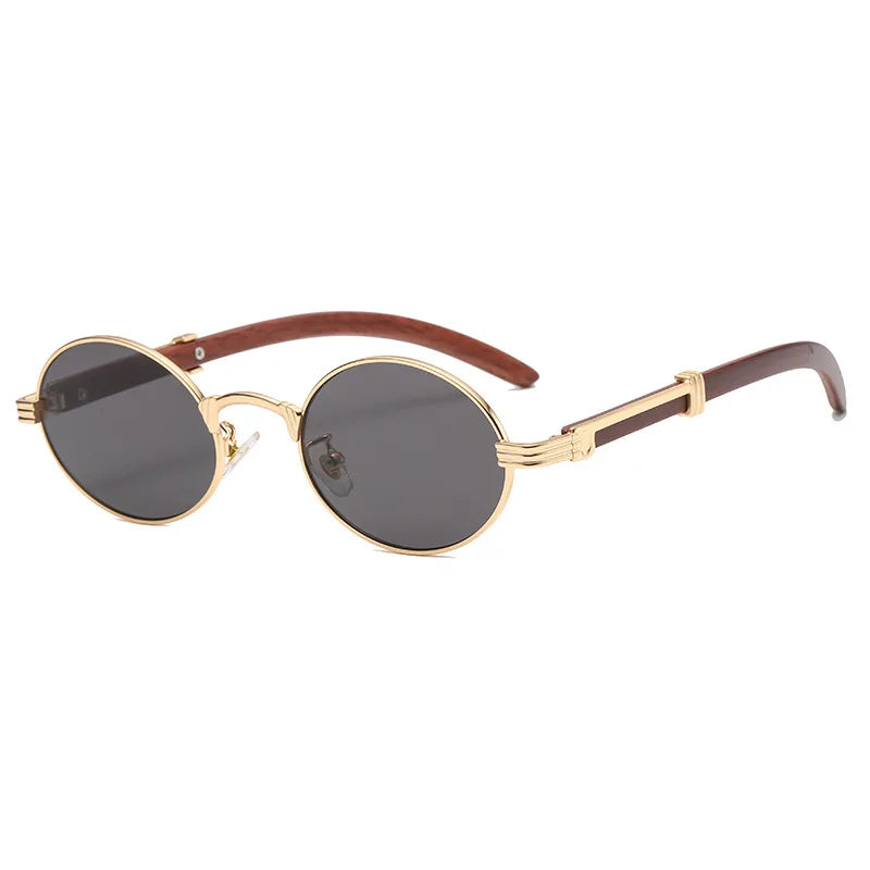 Gold-rimmed oval vintage sunglasses with dark lenses and brown arms, featuring decorative wing-like details on the hinges. These Nautical Shades offer UV400 protection and are positioned at an angle on a white background.