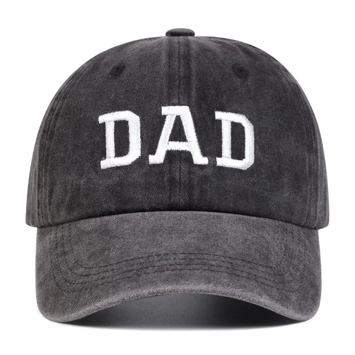 A black embroidered cap with DAD in bold white letters on the front, perfect for vintage streetwear lovers and those seeking a classic Mom & Dad cap style.