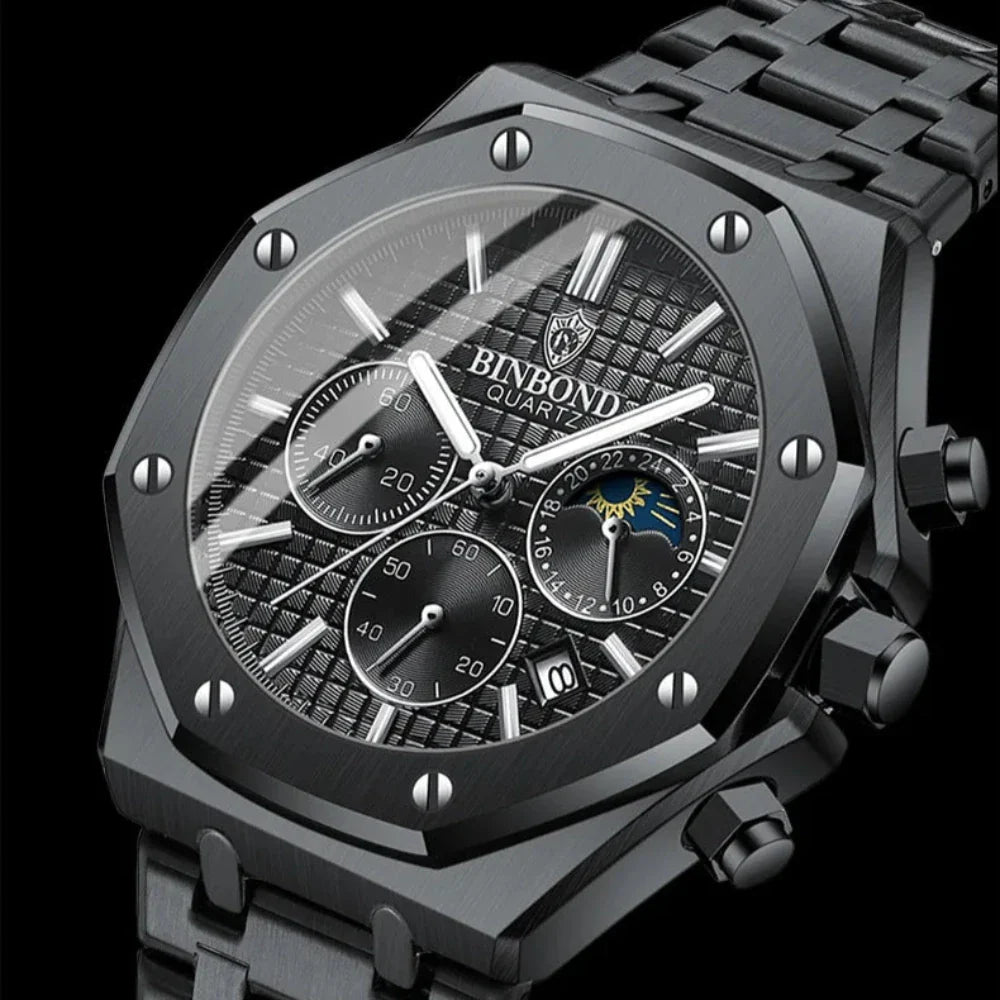 A close-up of a black BINBOND stainless steel watch with a textured dial, chronograph dials, date window, silver markers, and a metal link band on a black background.