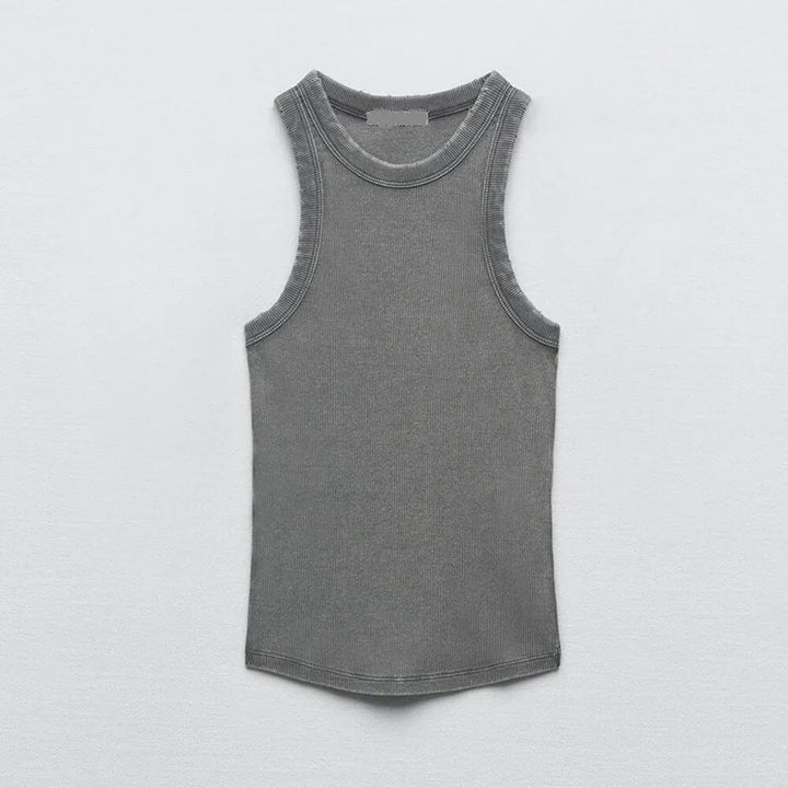 A sleeveless, water wash rib women's tank top in gray is laid flat on a light gray surface, showing its front side and simple round neckline for a subtle retro workwear vibe.