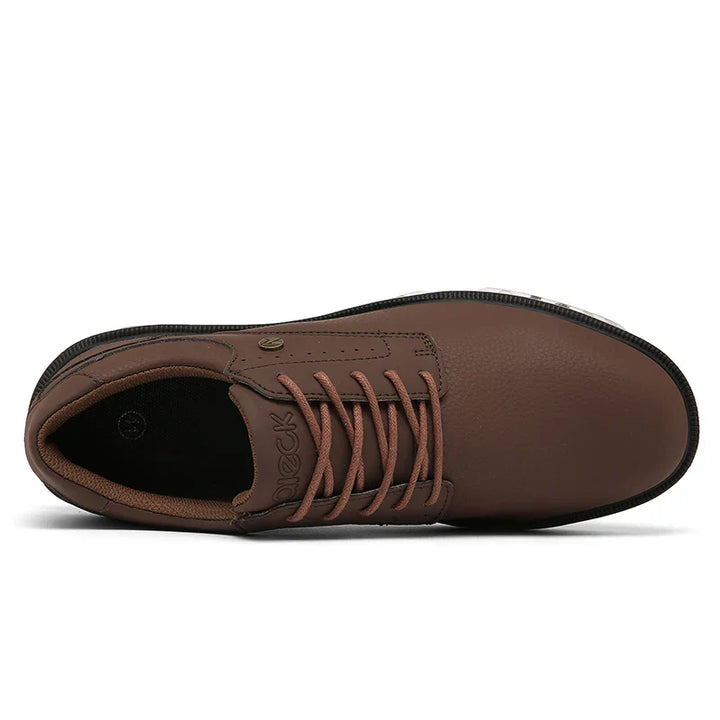 Top view of a brown lace-up shoe with a textured finish, five eyelets on each side, a rounded toe, and black sole. Features include a reinforced toe cap and brown interior lining and tongue.