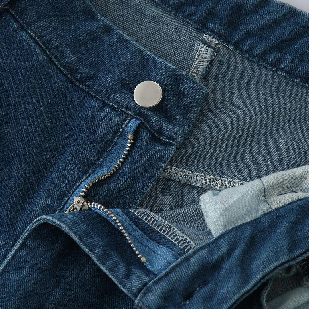 Close-up of a pair of relaxed fit blue jeans with the zipper partially open and the metal button undone, highlighting the high waist, waistband, and stitching details.