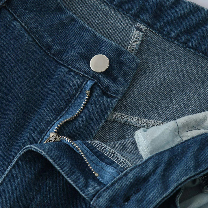 Close-up of a pair of relaxed fit blue jeans with the zipper partially open and the metal button undone, highlighting the high waist, waistband, and stitching details.