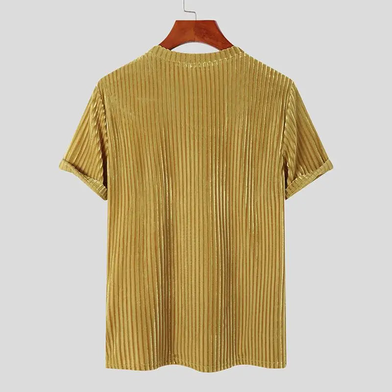 A gold-colored, short-sleeve, stripe corduroy tee in a classic fit is displayed on a wooden hanger against a plain light gray background. The ribbed velvet shirt is shown from the back.