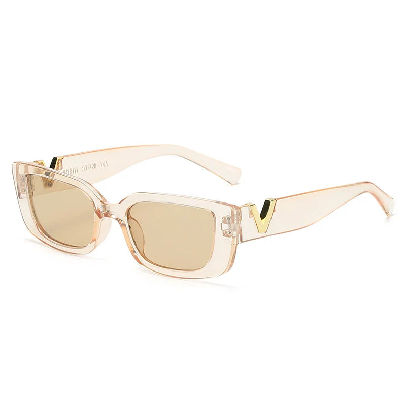 Rectangular designer sunglasses with transparent peach-colored geometric frames, light brown lenses, UV400 protection, and gold V-shaped accents on the temples.