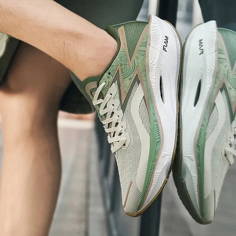 Close-up of a person wearing light green and white athletic sneakers with geometric patterns, sitting outdoors with legs crossed. The ultra-lightweight shoes have FUMI printed on the side of the shock-absorbing sole.