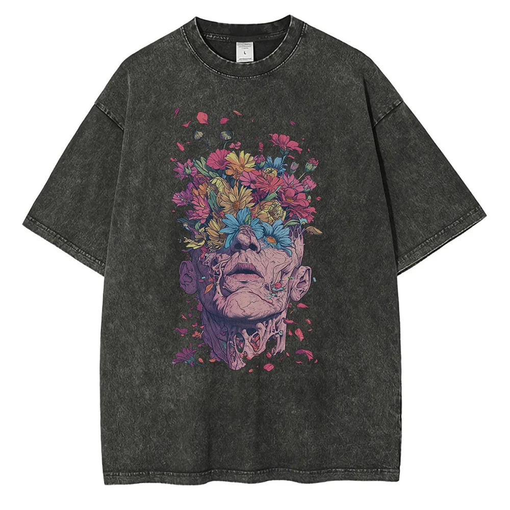 A black oversized fit T-shirt crafted from premium cotton features a vibrant graphic design of a face with the top dissolving into blooming flowers, merging surreal art with floral elements.