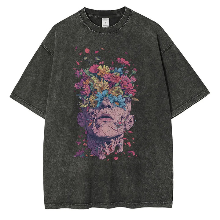 A black oversized fit T-shirt crafted from premium cotton features a vibrant graphic design of a face with the top dissolving into blooming flowers, merging surreal art with floral elements.