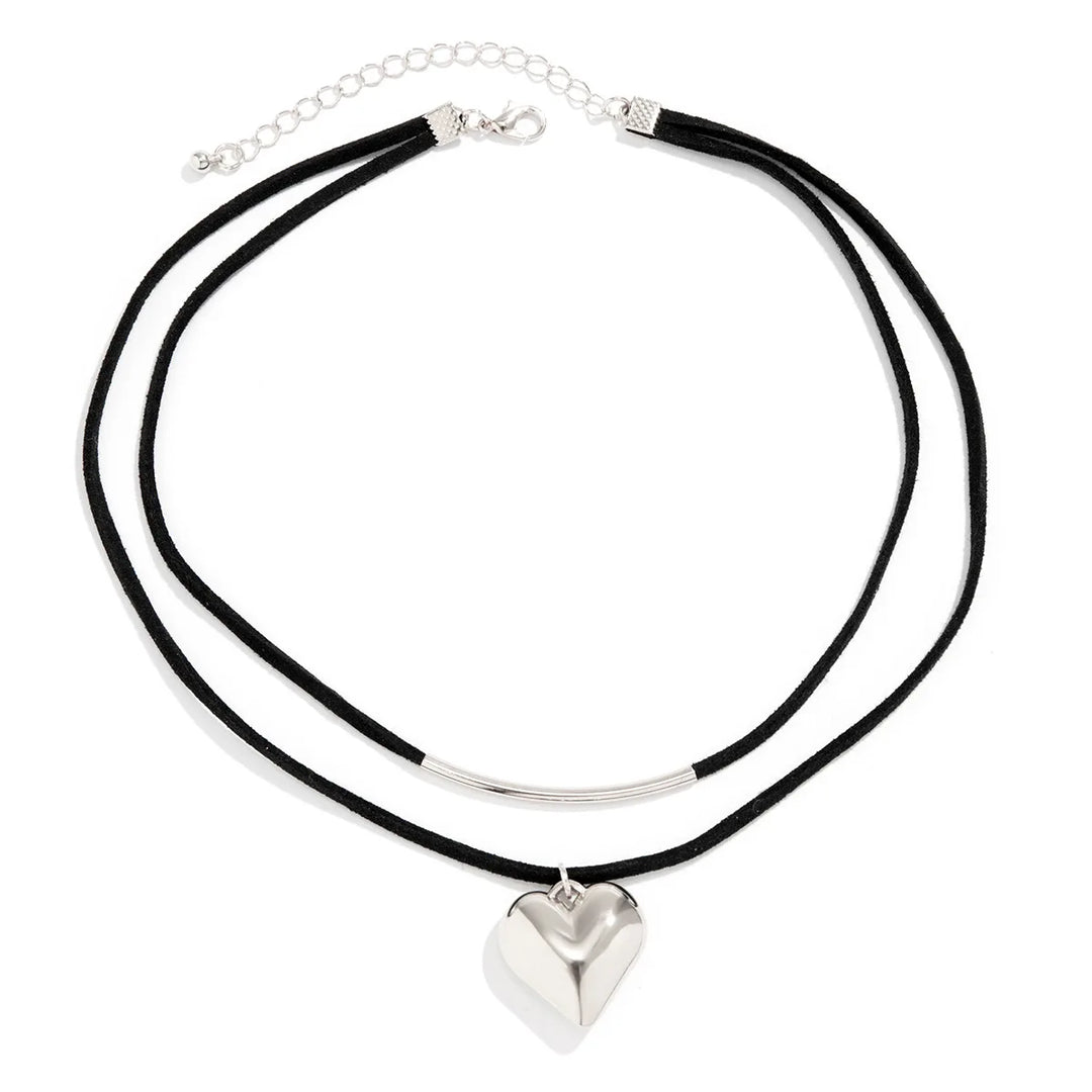 A double-layer black cord necklace features a silver metal curved bar on the upper layer and a vintage heart pendant on the lower, finished with an adjustable choker clasp for the perfect fit.