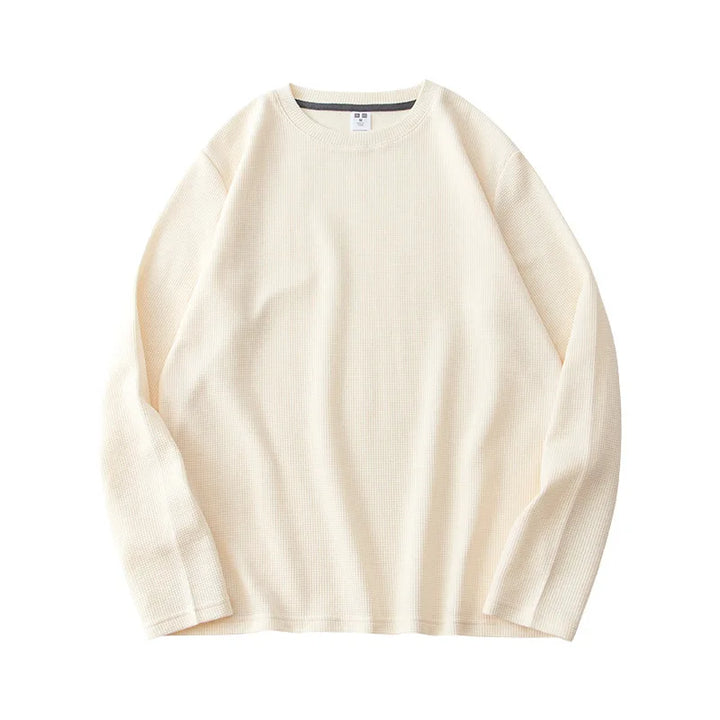 A white waffle knit sweater crafted from premium cotton, displayed on a white background.