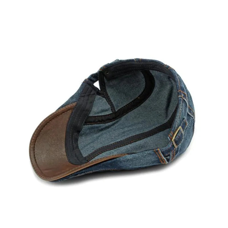 A cotton denim baseball cap turned inside out, showing the inner stitching, black sweatband, and brass buckle on the adjustable strap—offering casual style and sun protection against a white background.