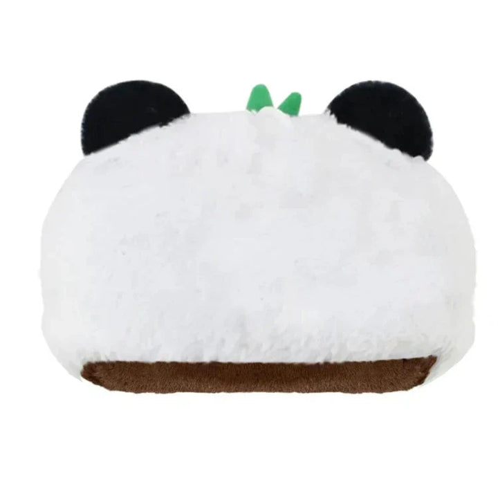 A plush pillow shaped like a panda head, featuring black ears, green felt leaves on top, and a brown bottom mouth area, all crafted from soft plush material against a white background.