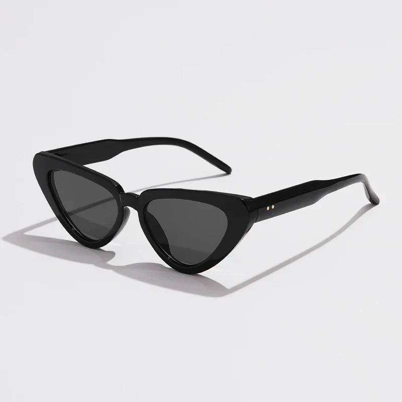 Black cat-eye sunglasses with dark lenses, angled arms, and a glossy finish offer UV400 sun protection. This lightweight eyewear is displayed on a white background.