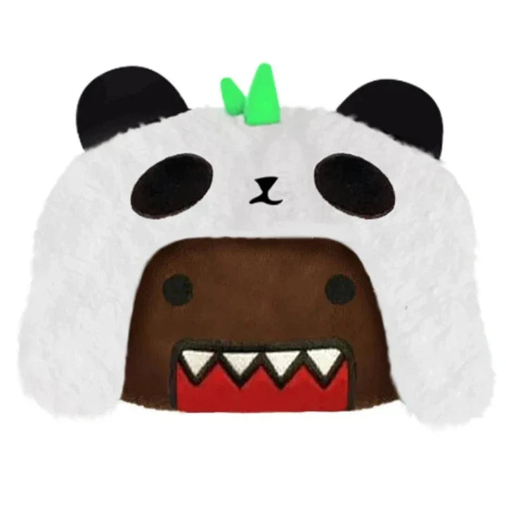 A plush Domo character with a wide, red, jagged mouth wears a fuzzy panda hood featuring plush material, black ears, round black eyes, and a small green tuft on top.