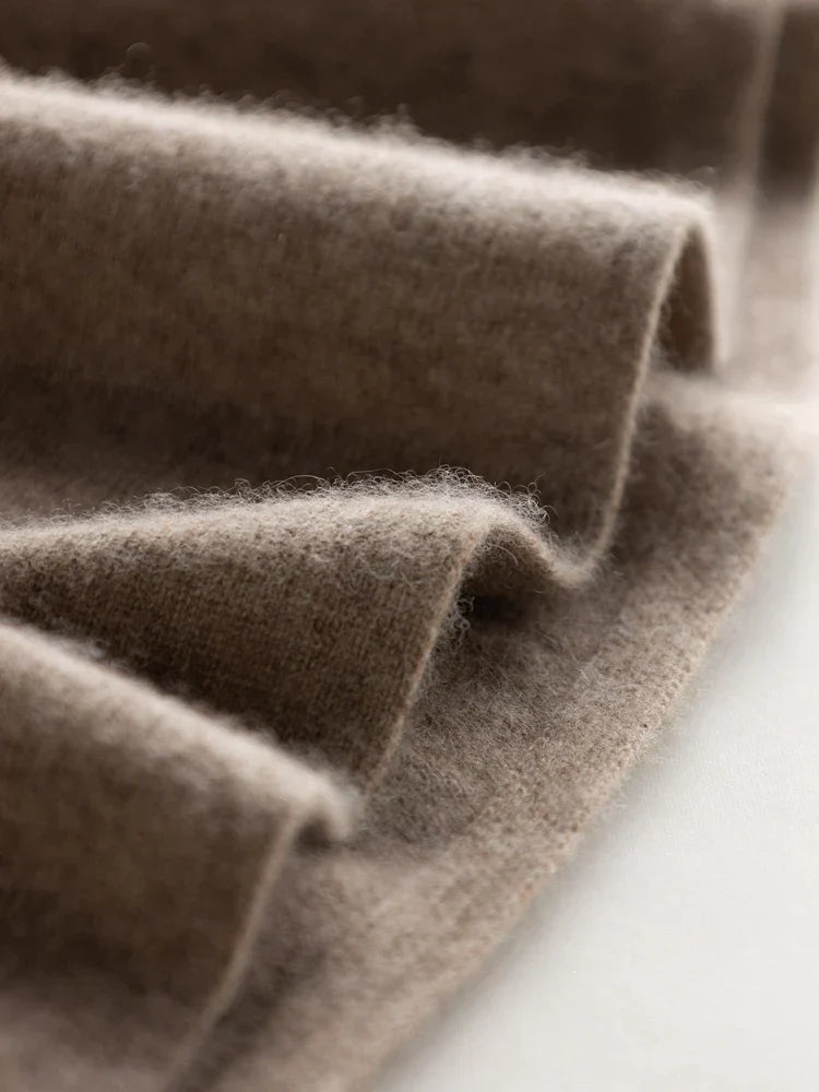 Close-up of soft, folded brown wool or cashmere fabric with a fuzzy texture, showing gentle waves and a smooth surface—perfect for crafting a cozy V-neck wrap or luxurious Matilda Wrap Dress.