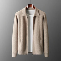Beige zip-up cardigan with a collar, long sleeves, and two side pockets, crafted from moisture-wicking merino wool, displayed on a wooden hanger over a plain white t-shirt against a gray background.