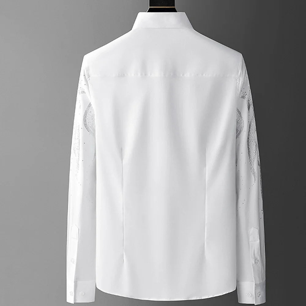 A long-sleeve white tailored fit shirt is shown from the back against a neutral gray background, featuring a classic collar and buttoned cuffs. Subtle patterns are slightly visible on the sleeves.