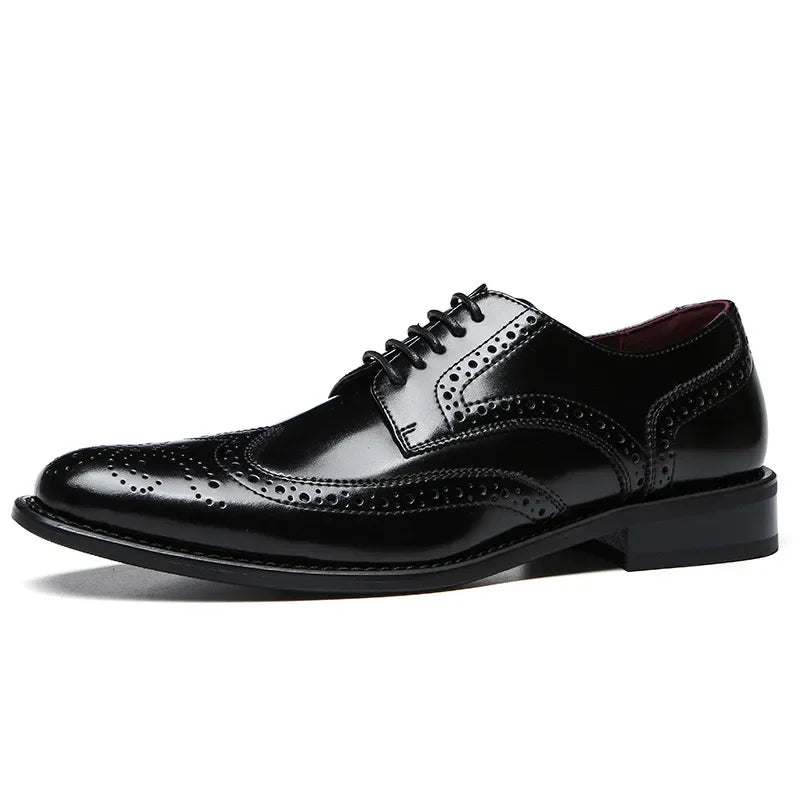A shiny black premium leather brogue wingtip dress shoe with detailed broguing, lace-up closure, cushioned insole, and a low heel, photographed on a white background.