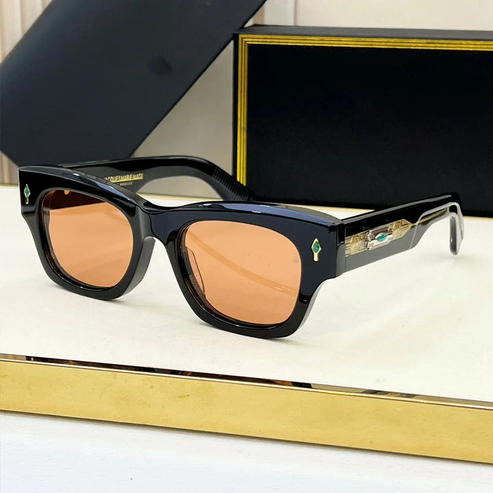 Black rectangular retro sunglasses with brown-tinted lenses, featuring small turquoise and gold details on the arms. These vintage-inspired sunglasses offer UV400 protection and are displayed with a black case and frame on a white and gold surface.