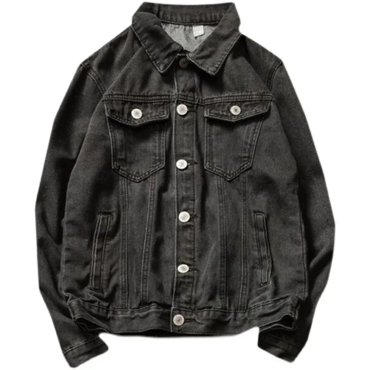 A black button-down denim jacket crafted from premium denim, featuring a relaxed silhouette, a collar, two chest pockets with flaps and buttons, two side pockets, visible stitching, and silver buttons.