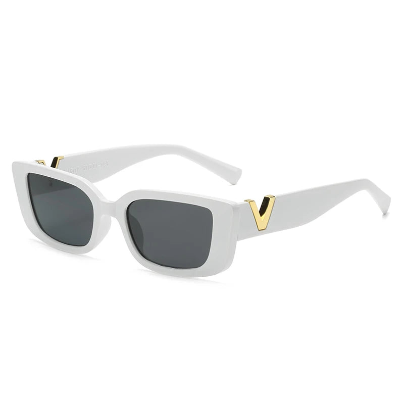 White, rectangular designer sunglasses with black lenses and thick geometric frames. The arms feature a gold V accent near the hinges, adding a stylish detail. These sunglasses offer UV400 protection. The background is plain white.