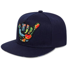 A navy blue Hang Loose Snapback featuring an embroidered shaka hand sign filled with a colorful tropical floral pattern on the front panel—perfect for that Hawaiian-inspired cap vibe.