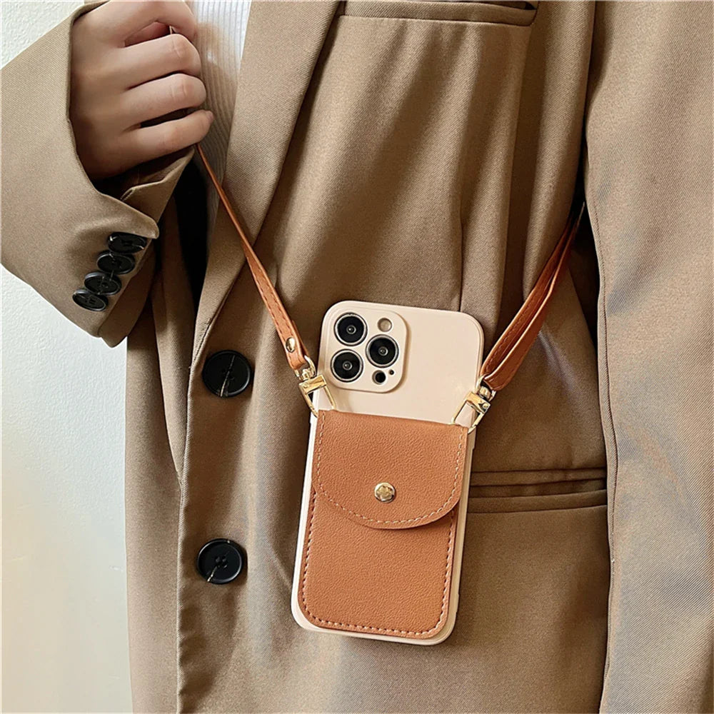 A person wearing a beige coat holds a phone in a beige and brown phone case wallet with a secure cardholder and gold hardware. The phone hangs from a leather detachable strap around their neck.