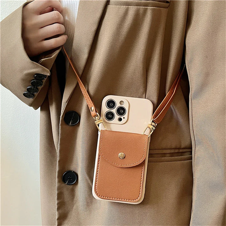 A person wearing a beige coat holds a phone in a beige and brown phone case wallet with a secure cardholder and gold hardware. The phone hangs from a leather detachable strap around their neck.
