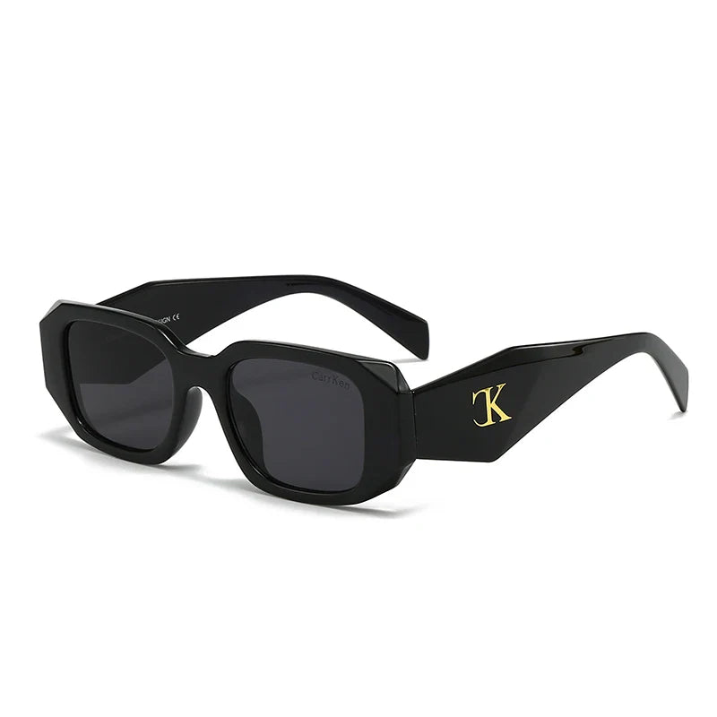 Oversized acetate sunglasses with black rectangular frames, reinforced hinges, dark UV400 protection lenses, and a gold “TK” logo on the temples, displayed on a white background.